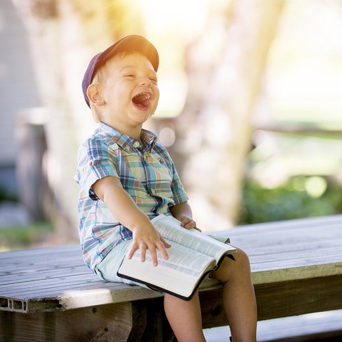 young boy reading a book